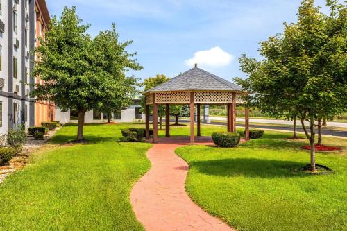 a gazebo in a park next to a building at Days Inn and Suites by Wyndham Hammond, IN in Hammond