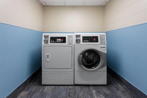 a laundry room with a washer and dryer at Days Inn and Suites by Wyndham Hammond, IN in Hammond