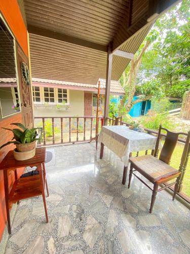a patio with a table and two chairs and a table at Chomklong Experience in Pak Chong