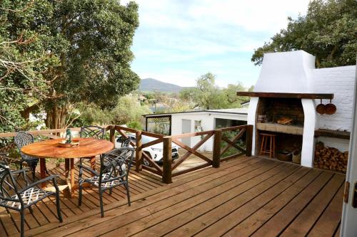 a deck with a table and chairs and a grill at Family Home in Napier in Napier