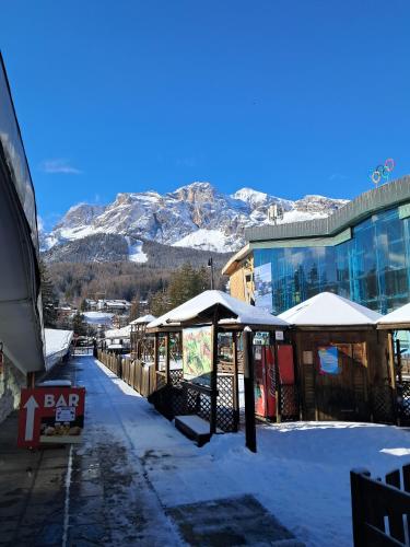 a snow covered street with mountains in the background at Casa Francesco in Peaio