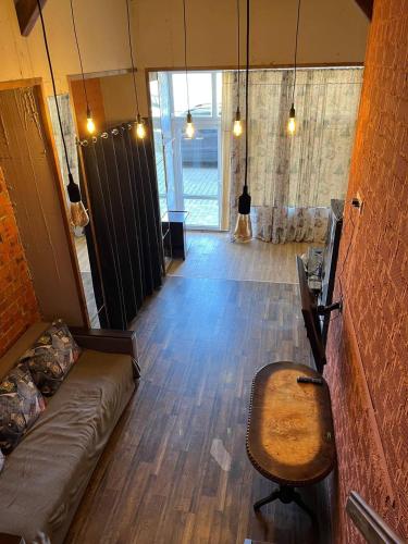 a living room with a couch and a chair at Стадия лофт 2 in Chornomorsk