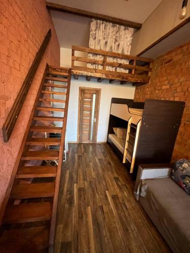 a room with a staircase and bunk beds at Стадия лофт 2 in Chornomorsk