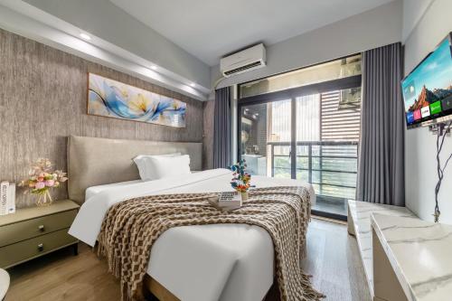 Ένα ή περισσότερα κρεβάτια σε δωμάτιο στο Mihua Times You Apartment