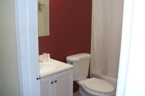 a bathroom with a white toilet and a sink at Budget Inn & Suites in Wall Township