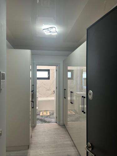 a bathroom with a walk in shower and a glass door at Adamant Towers Loft in Iaşi