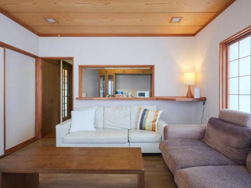 a living room with a couch and a table at Misaki Guesthouse in Kofu