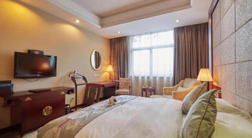 a hotel room with a bed and a television at Huangshan International Hotel in Huangshan