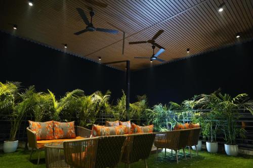 a patio with a couch and chairs and plants at Hotel Northern View in Chandīgarh