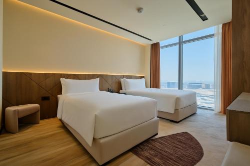 Una cama o camas en una habitación de The OQ