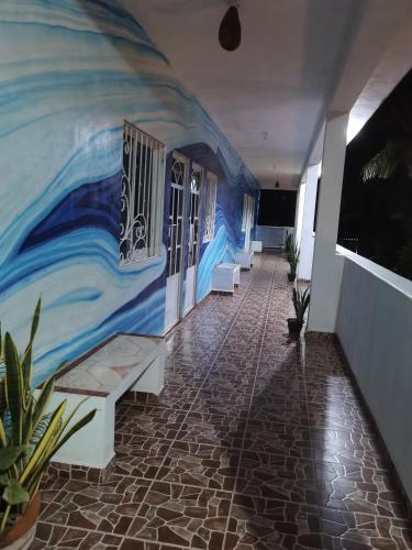 a hallway with a mural on the side of a building at Blue Hotel in Bacalar