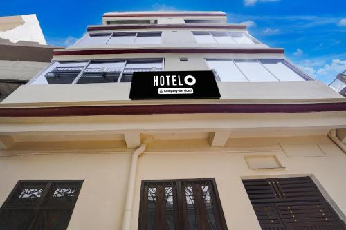 a hotel sign on the side of a building at Super Hotel O Prayagraj Sangam Railway Junction Formerly Veni Madhv Inn in Dārāganj