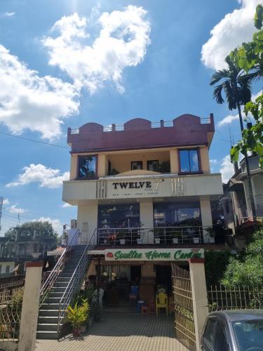 a building with stairs in front of it at Mountain Breeze in Panchanai