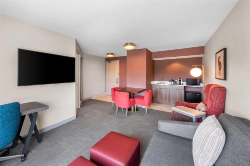 a living room with a couch and a table at Hilton Garden Inn Overland Park in Overland Park