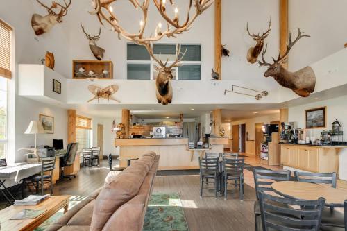 a living room with a couch and tables and chairs at Quality Inn Belgrade - Bozeman Yellowstone Airport in Belgrade