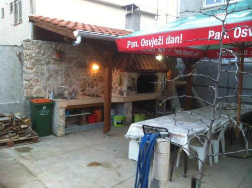 a building with a table in front of a building at Rooms Ivica Vodice in Vodice