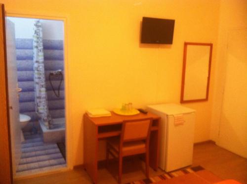 a small room with a table and a sink and a bathroom at Rooms Ivica Vodice in Vodice
