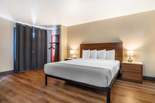 a hotel room with a bed and two lamps at La Luna Inn, an Ascend Collection Hotel in San Francisco