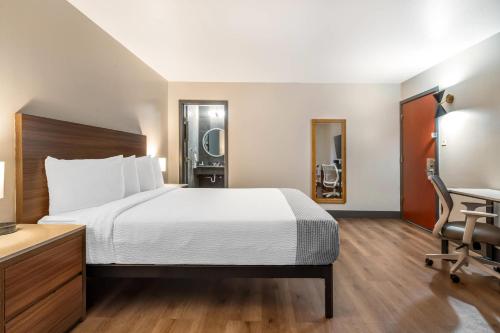 a hotel room with a bed and a desk at La Luna Inn, an Ascend Collection Hotel in San Francisco