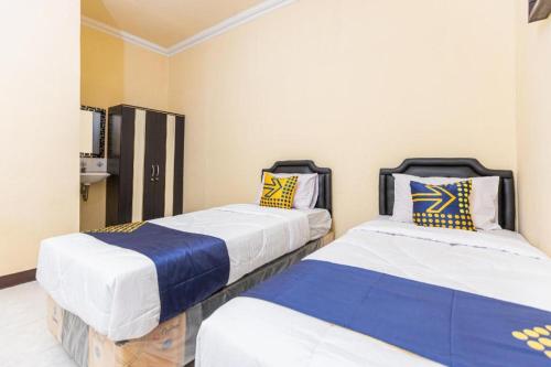 Postel nebo postele na pokoji v ubytování Hotel O Pondok Ripuji