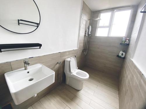 Un baño con lavabo, inodoro y espejo. en LV10 The Greywoodz 1-4pax Kuantan, en Kuantan