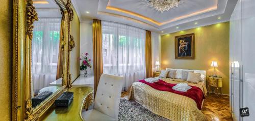 a bedroom with a bed and a large mirror at BP Apartments Budapest in Budapest