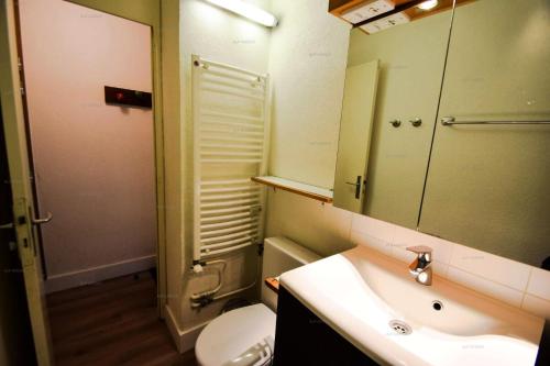 a bathroom with a sink and a toilet and a mirror at Résidence Le Mustag - 3 pièces 6 personnes - LE MUSTAG -026MU- PLAGNE CENTRE MAE-0283 in Aime La Plagne