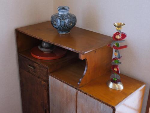 a wooden shelf with a vase on top of it at Misaki Guesthouse in Kofu