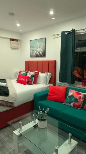 a living room with a bed and a couch at 70A Walsall Stylish 1 Bedroom King Size And Sofa bed 3 sleeps WiFi & Garden in Birmingham