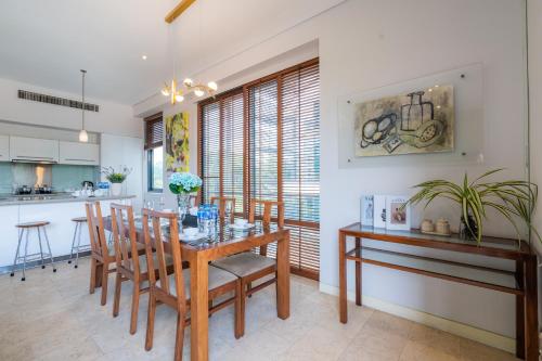a kitchen and dining room with a wooden table and chairs at Park view Avalon Apartment District 1 HCM City in Ho Chi Minh City