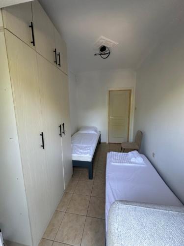 a small room with two beds and a closet at Address Haidari in Athens