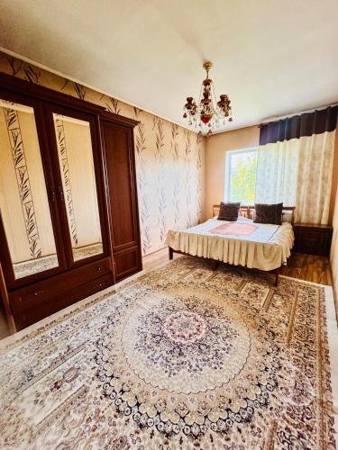 a bedroom with a bed and a large rug at Cottage Лома city center 7 to 2 floor in Taldykorgan