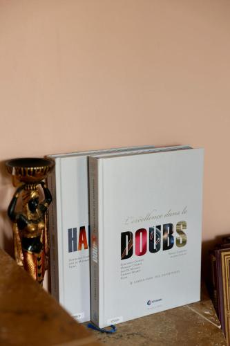 two books stacked on top of each other on a table at Lovely House in Besançon