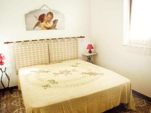 a bedroom with a bed with a blanket on it at Case Vacanza Tra I Due Monti in Valderice