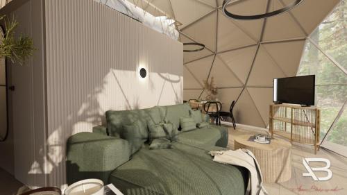 a living room with a green couch and a tv at Glamping "Letnisko WISOLA" in Ciemnik