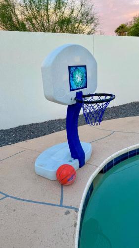a basketball hoop in front of a swimming pool at NEW PHX Pool Home With Deep End and Central Location in Phoenix