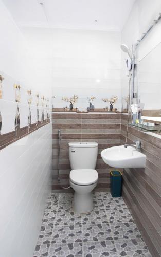 a bathroom with a toilet and a sink at HeavenVilla in Can Tho