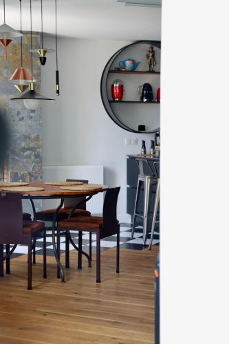 a dining room with a wooden table and chairs at Lovely House in Besançon