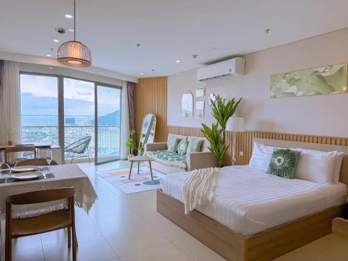 a bedroom with a bed and a living room at HomeAway - The Sóng Vũng Tàu LUX Condotel in Vung Tau