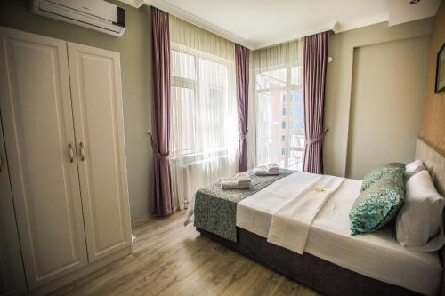 a bedroom with a bed and a large window at Doa Suite Hotel in Trabzon