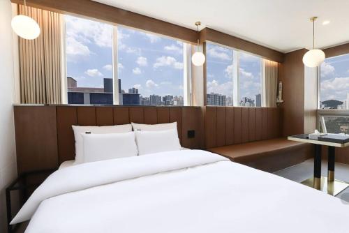 Ένα ή περισσότερα κρεβάτια σε δωμάτιο στο Wonju Urban Brown Hotel