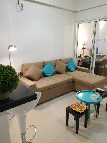 a living room with a couch and a table at La Vista One The Cosy Sofa-Bed Studio in Chennai