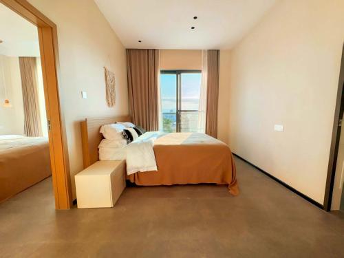 a hotel room with a bed and a large window at Shiguang Wai · Manhai Yunshe Homestay in Dali Ancient Town