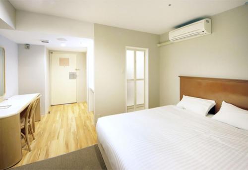 Ένα ή περισσότερα κρεβάτια σε δωμάτιο στο Quintessa Hotel Akita