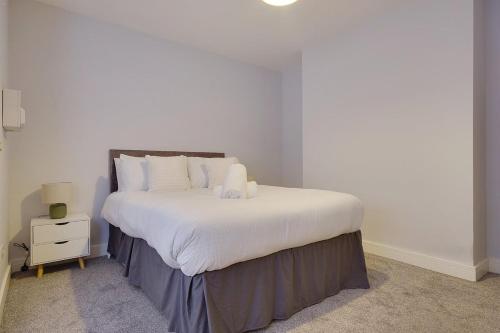 a bedroom with a large bed with white sheets at Palmerston Road in Bournemouth