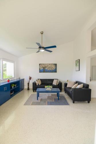a living room with a couch and a table at Casa Jobo Scenic ViewsPrivate Pool TablePool in Gurapito