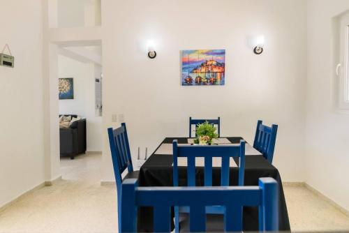 a dining room with a blue table and chairs at Casa Jobo Scenic ViewsPrivate Pool TablePool in Gurapito