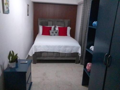 a bedroom with a bed with red pillows at Casa Jobo Scenic ViewsPrivate Pool TablePool in Gurapito