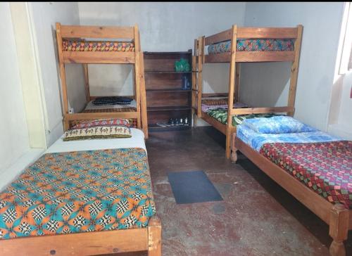 a room with two bunk beds in a room at Lusaka Backpackers in Lusaka