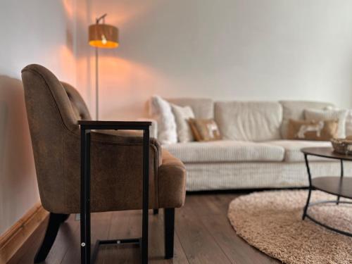 a living room with a couch and a chair at Modern House with four BR two parking bays in Bolton in Bolton